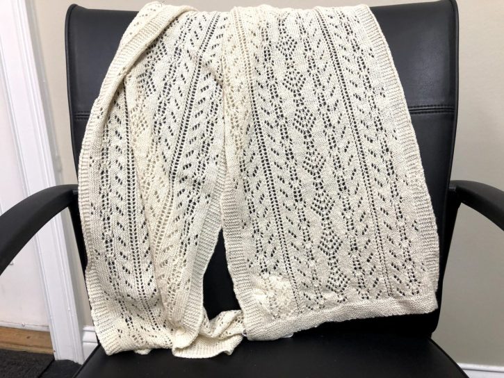 Aspen Arnetta Alpaca scarf made from Aspen's fleece, laying on black chair