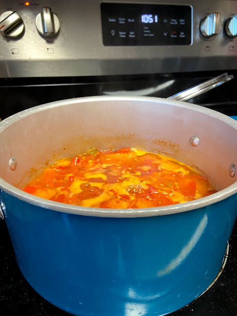 mixed tomatoes cooking to make homemade tomato sauce