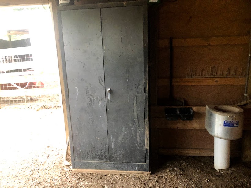 metal cabinet next to alpaca mineral feeder and nelson automatic waterer