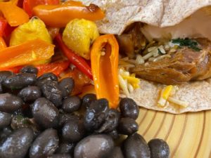 lamb shank tacos with black beans, peppers, and plantains