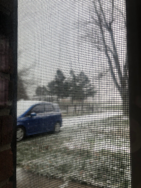 blue Honda Fit as snow is starting