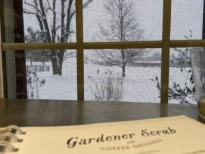 gardener scrub recipe from soap room table looking out at snow
