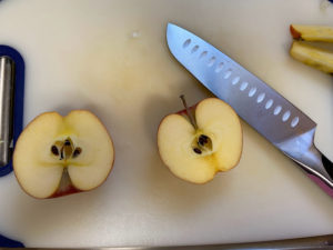 apple cut in half with knife