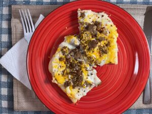 two pieces breakfast pizza on red plate
