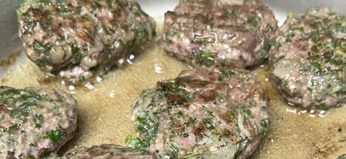 lamb, parsley, and onion sliders cooking in skillet